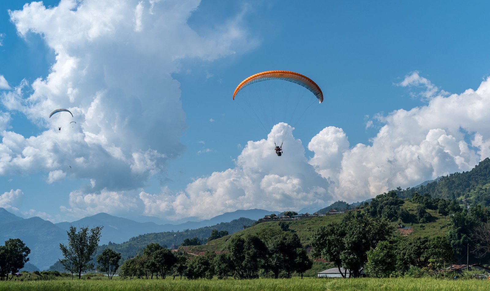 landing with parachute after paragliding in Pokhara. Nepal