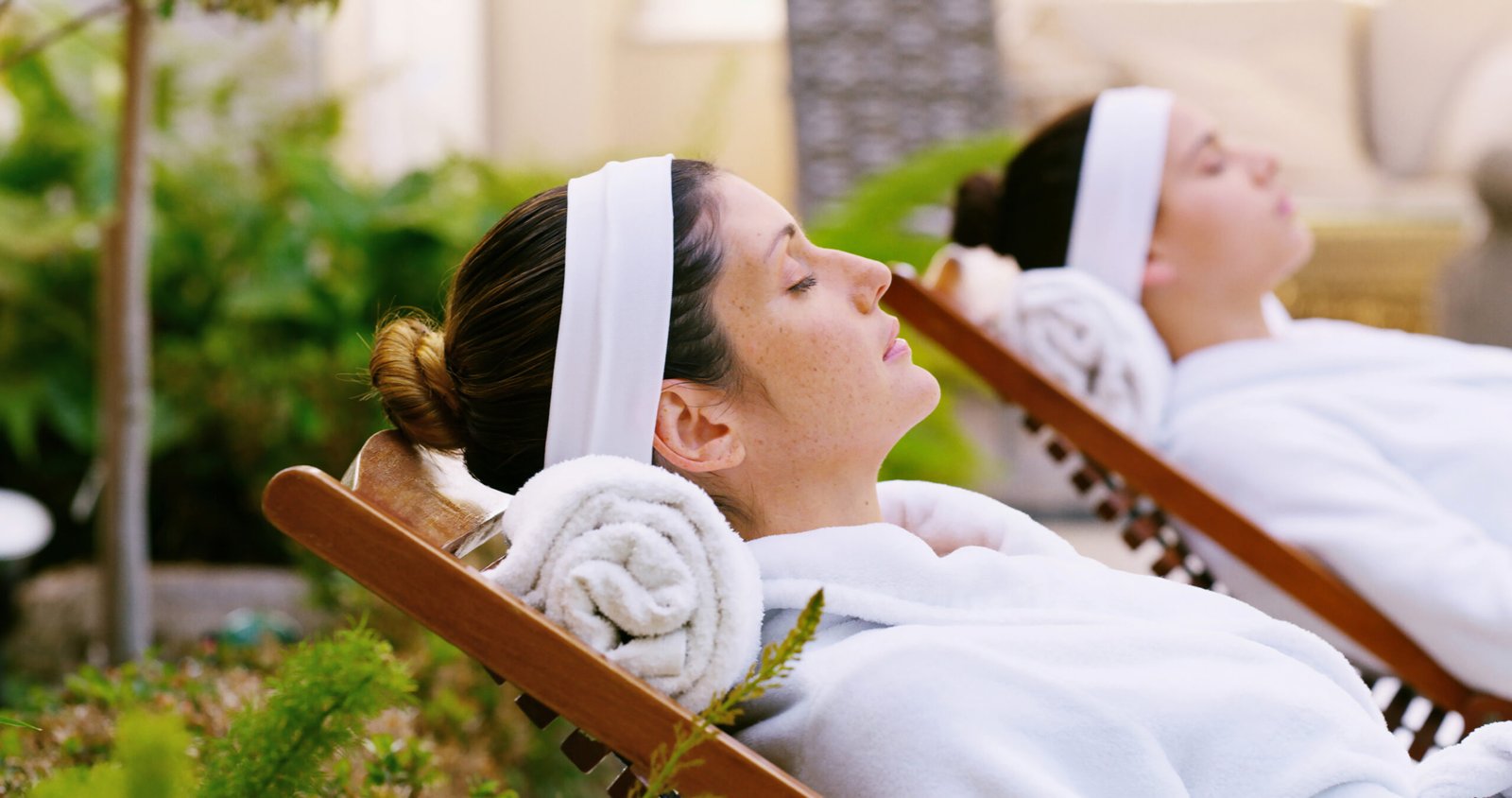 Resort, woman and relax in robe by spa for weekend break, stress relief or luxury treatment outdoor.