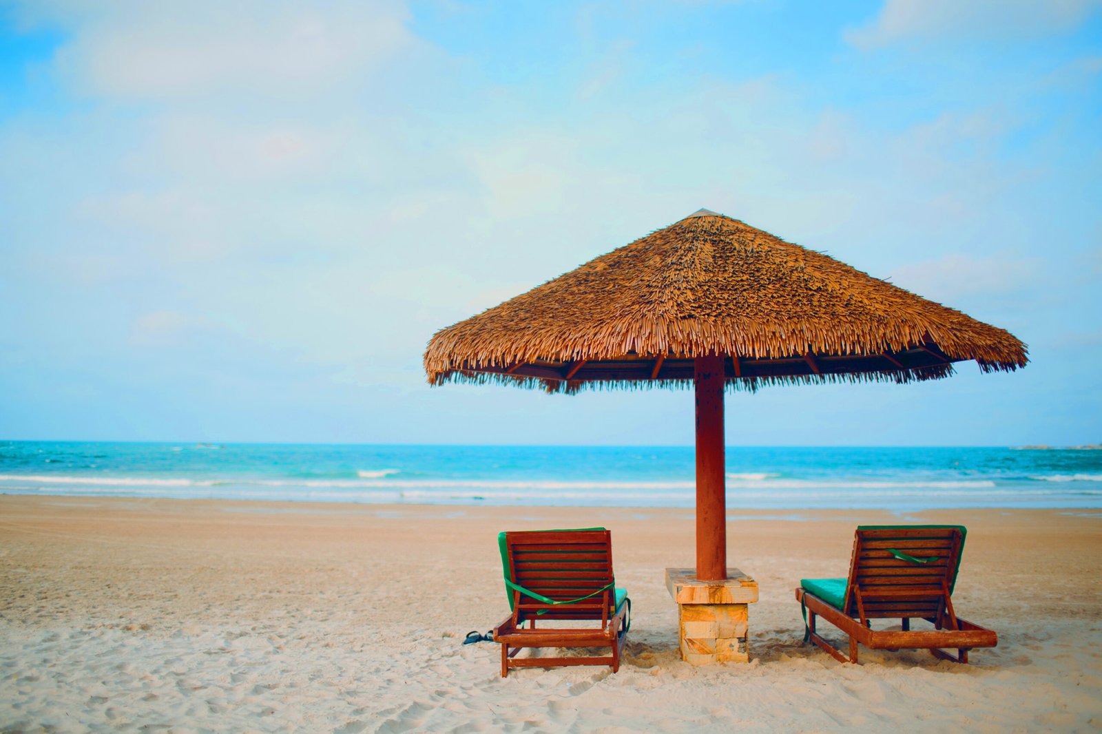 Two sun loungers and umbrella on the beach