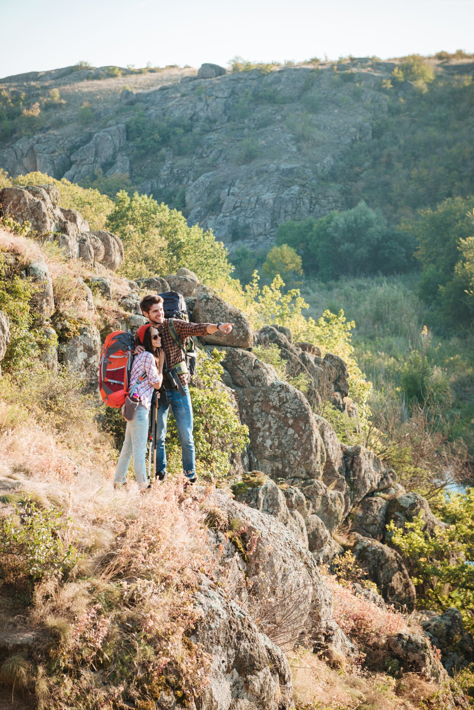 Vertical image of traveling couple near the canyon. full length image